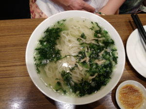 kaohsiung din tai fung noodle soup with mustard greens and shredded pork